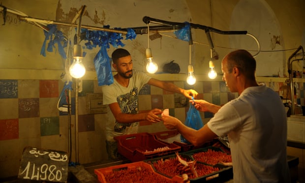 A man buys food at a fish stall