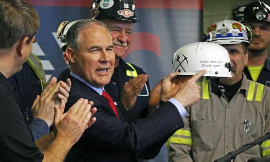 Scott Pruitt holds up a hardhat during his visit to the Harvey mine.