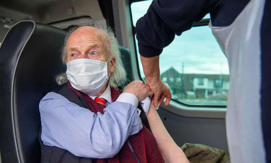 A man receives a booster shot at a mobile NHS  vaccination clinic in Dedworth, Berkshire