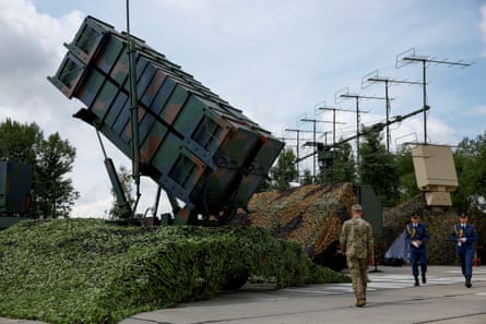 Ukrainian service members view a Patriot air defence system in 2024.