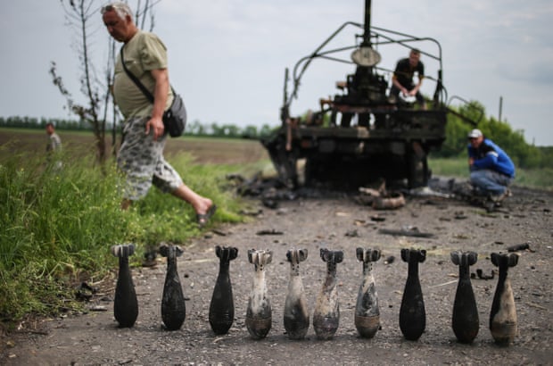 Locals in Slavyansk examine the aftermath of a military clash between separatists and Ukrainian forces, May 2014.