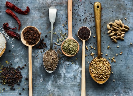 Anna Jones Feast Spice Mix. A number of spoons full of spices arranged artfully on a table.