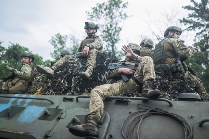 Ukrainian servicemen travel on a wheeled-BTR fighting vehicle near Bakhmut in the Donetsk region of Ukraine.
