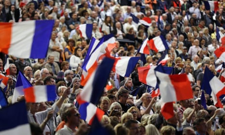 People wave the French national flag during a campaign meeting of presidential election candidate François Fillon, for the right-wing Les Republicains party, on 17 April, in Nice.