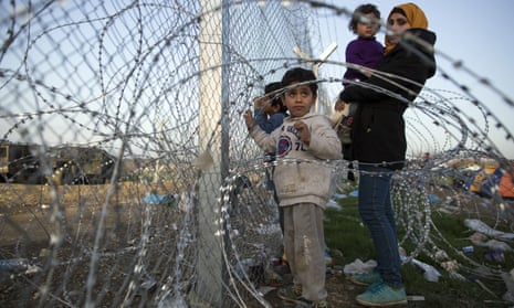 Families gather at the fence at the Greek-Macedonia border near Idomeni, Greece