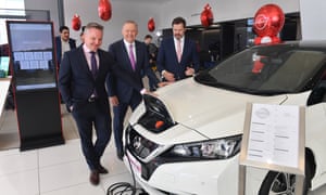 Shadow Minister for Climate Change Chris Bowen, Leader of the Opposition Anthony Albanese and Shadow Minister for Industry Ed Husic with an electric vehicle at a car dealership