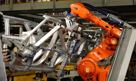 A robot works on cars at Jaguar Land Rover, in Solihull, West Midlands.