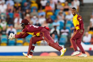 Nicholas Pooran (L), of West Indies, takes the catch to dismiss Jason Roy, of England.