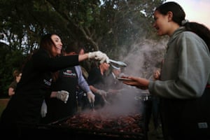 Ardern helps cook breakfast for the crowds after a dawn service in Waitangi on Waitangi Day at 2021