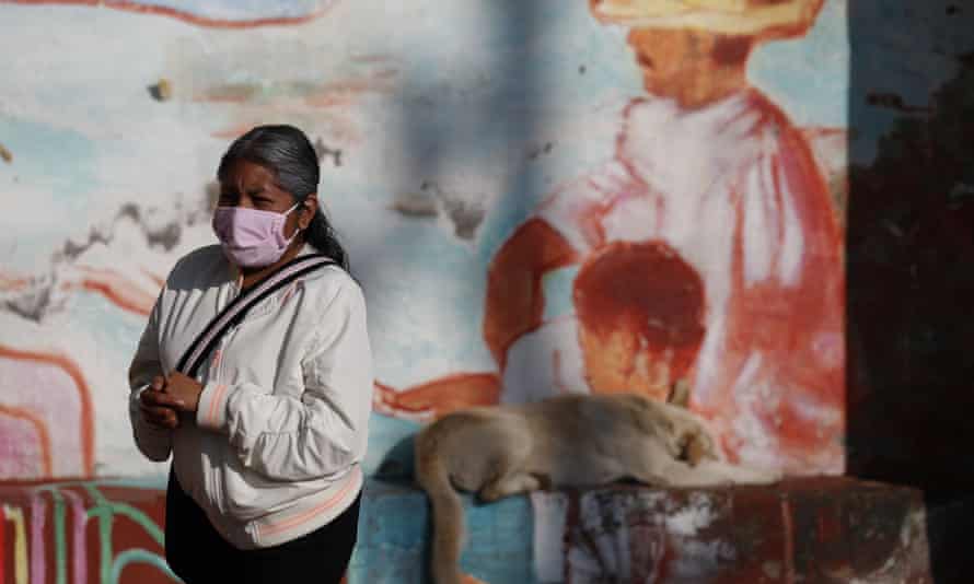 A woman rubs antibacterial gel into her hands as she waits in a distanced line to get tested for Covid-19 at a mobile diagnostic tent in San Gregorio Atlapulco in the Xochimilco district of Mexico City on Wednesday.