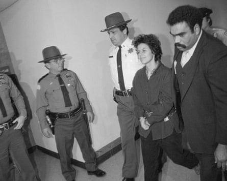 Police escort a handcuffed Judith Clark down a hallway during her arraignment.