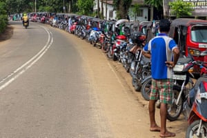 Pugoda, Sri Lanka. Motorists queue along a street to buy fuel at a petrol station