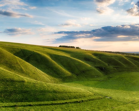 Green hills under a calm clear sky at dusk