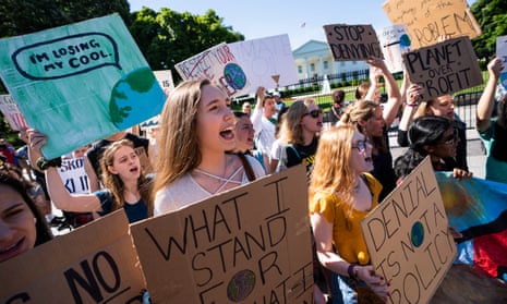 Protesters participate in a global climate strike outside the White House in Washington DC, on 24 May. 