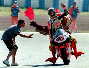 Following his success, Aprilla promoted Rossi to the 250cc category the following season. Despite a string of wins and podium finishes, Rossi finished second in that year’s championship. Pictured here after winning the Catalan Grand Prix at Montmelo, Rossi gives a ride to a fan in fancy dress. 