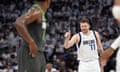 Dallas Mavericks guard Luka Dončić (77) celebrates his score as Minnesota Timberwolves guard Anthony Edwards, left, looks on during the Game 5 of the Western Conference finals on Thursday night.