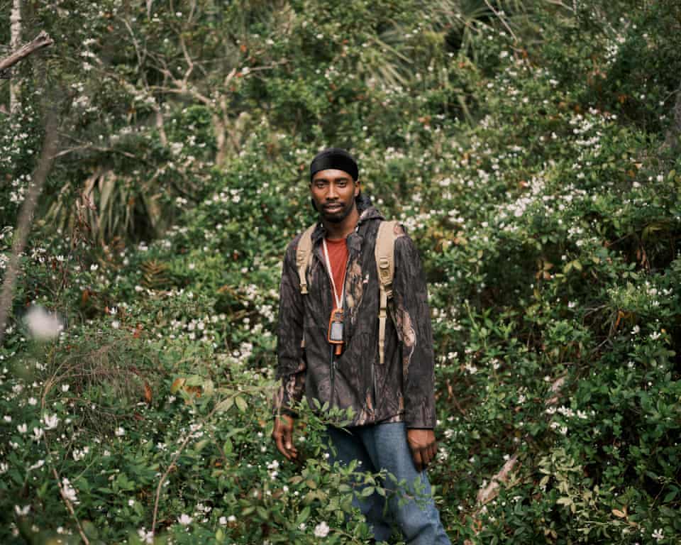 Pompi Rodriguez poses for a portrait as he goes hunting for feral hogs with his trained hunting dogs earlier this month in Poinciana, Florida.