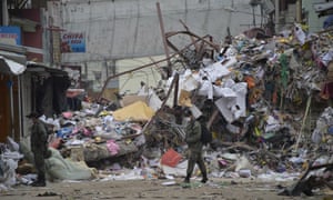 Security personnel stand guard on a street in Manta, Ecuador