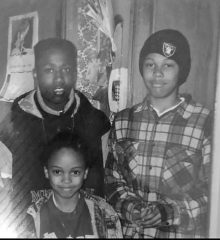 A photo of two teenage boys and a girl inside a house