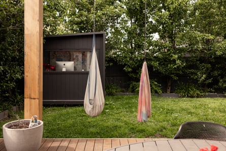 Clonan’s back yard has cocoon-like slings for the kids.