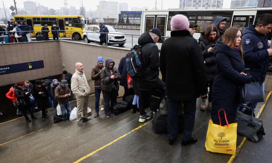 People wait at a bus station in Kyiv to go to western parts of the country on Thursday.