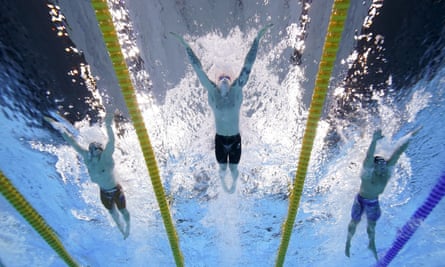 Adam Peaty (centre) on his way to a gold medal at the Tokyo Games in the 100m breaststroke.