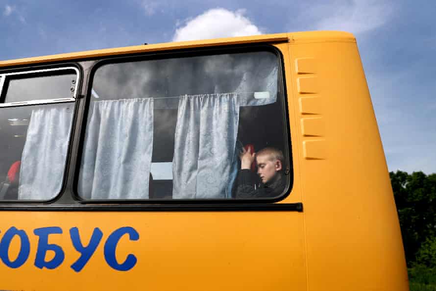 A child is seen travelling on an evacuation convoy on Monday.