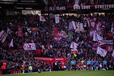 Fans cheer as the players, mascots and officials make their way onto the pitch.