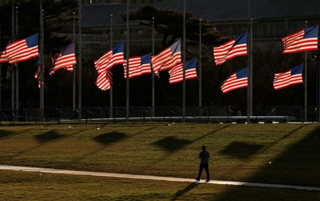 Biden calls Jimmy Carter ‘a statesman and a humanitarian’ as funeral details announced – latest updates A person walks past flags flying at half-staff at the Washington Monument.
