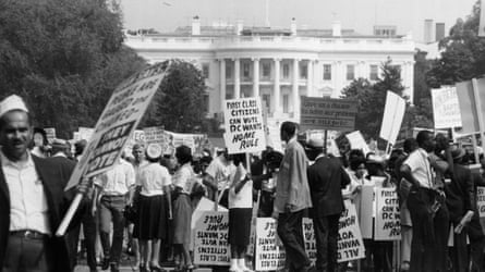 Protesters hold placards outside the White House