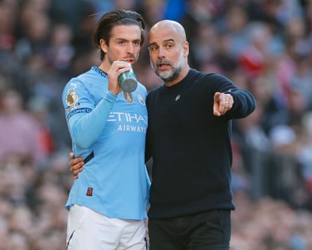 Pep Guardiola speaks to Jack Grealish