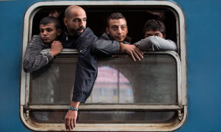Refugees board a train in Keleti station after it was reopened in central Budapest on 3 September.
