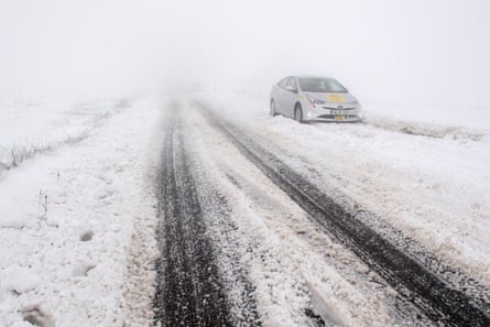 A taxi stuck in the snow on the A635 in Saddleworth Moor