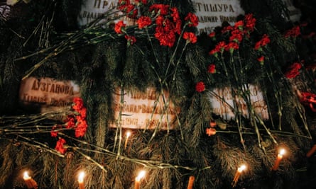 Flowers and candles are seen on the memorial of ‘Сhernobyl heroes’ during a ceremony in Kiev.
