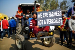 Farmers arrive in a tractor to attend a protest at Singhu