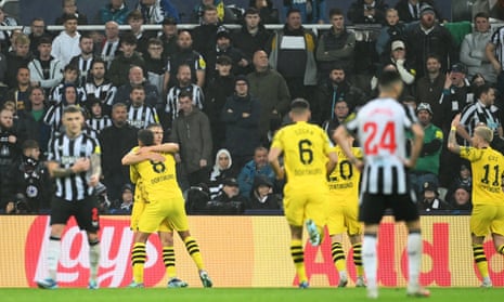 Felix Nmecha of Borussia Dortmund celebrates with teammate Nico Schlotterbeck after opening the scoring at Newcastle.