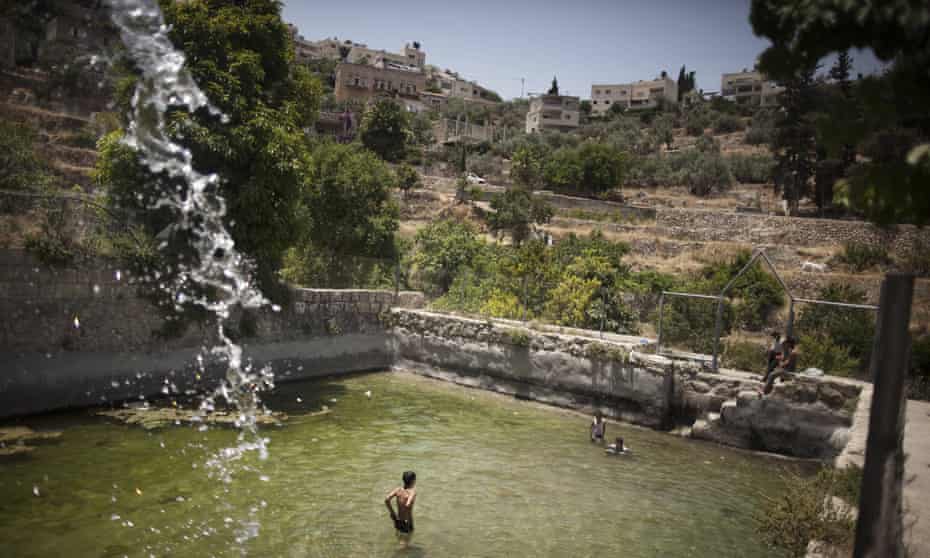 Palestinian children swim in the spring in the West Bank village of Battir.