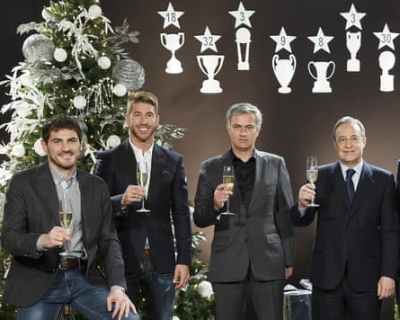 Real Madrid’s goalkeeper Iker Casillas, defender Sergio Ramos, manager José Mourinho and president Florentino Pérez pose with champagne glasses in front of a Christmas tree.