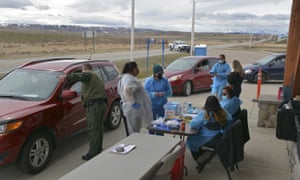 A US Border Patrol agent directs a driver after the passenger received a Covid-19 vaccine from nurses of the Blackfeet tribe at the Piegan-Carway border crossing near Babb, Montana.