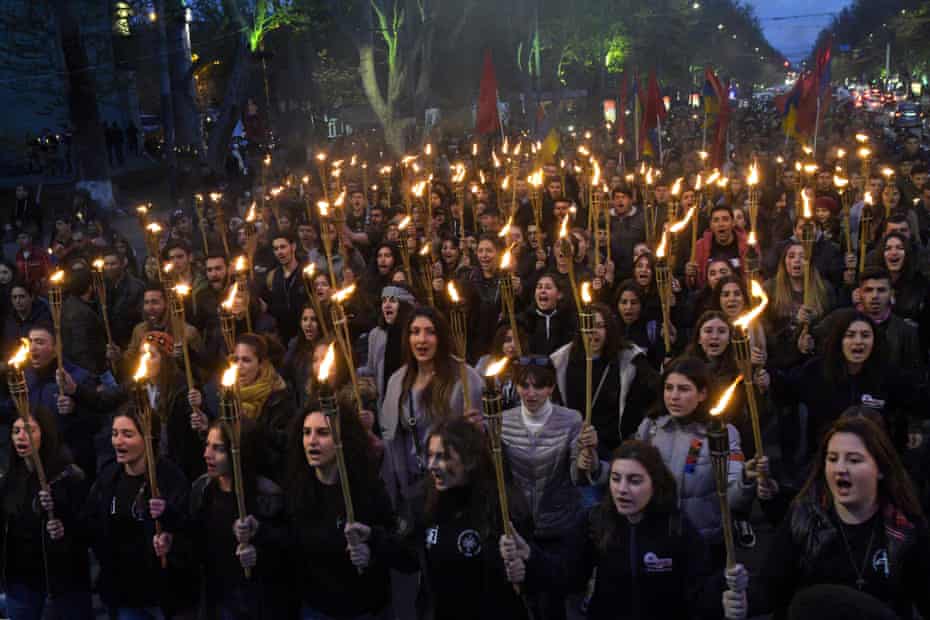 People take part in a torchlight procession as they mark the 104th anniversary of the killing of 1.5 million Armenians by Ottoman forces, Yerevan, Armenia.