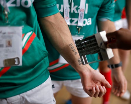 A competitor gets stamped on the forearm to verify his weight class.