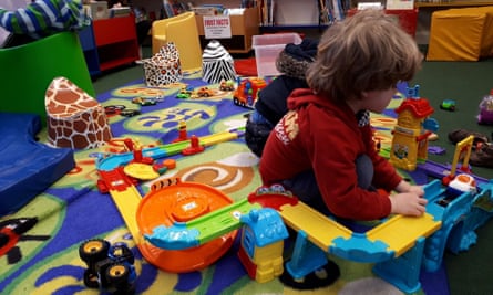 Young children playing with toys in a library