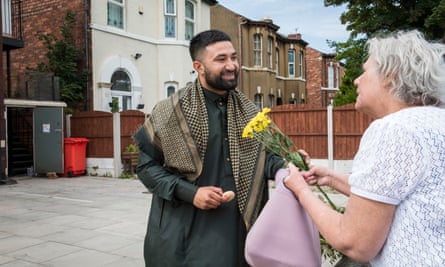 Locals handing out flowers and doughnuts outside the Southport mosque.
