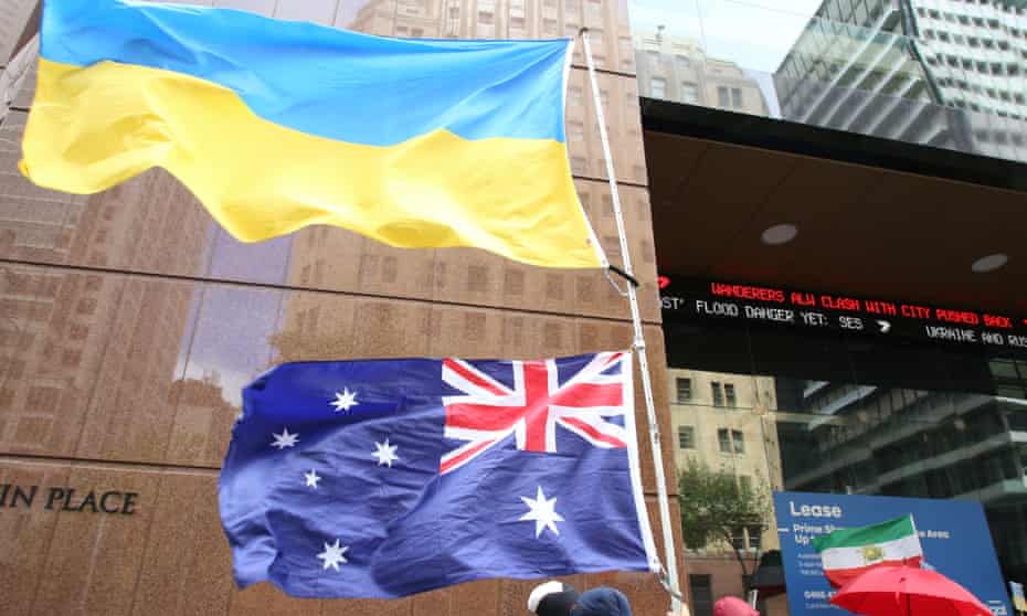 A Ukrainian flag and an Australian flag being flown by protesters at Martin Place in Sydney