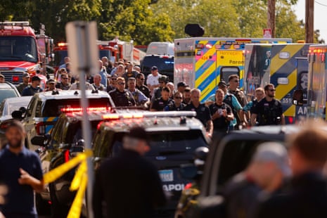 Law enforcement officers gather outside the Annunciation Church's school in response to a reported mass shooting, Wednesday, Aug. 27, 2025, in Minneapolis.