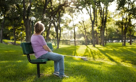 Woman sits on park bench
