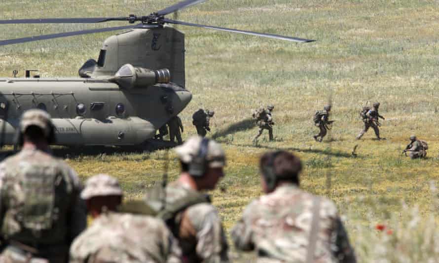 British soldiers deploy from a US helicopter during the Swift Response 22 military exercise at the Krivolak army training polygon in central North Macedonia.