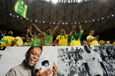 Brazil fans display banners with images of Pelé at their match with Cameroon in Qatar.