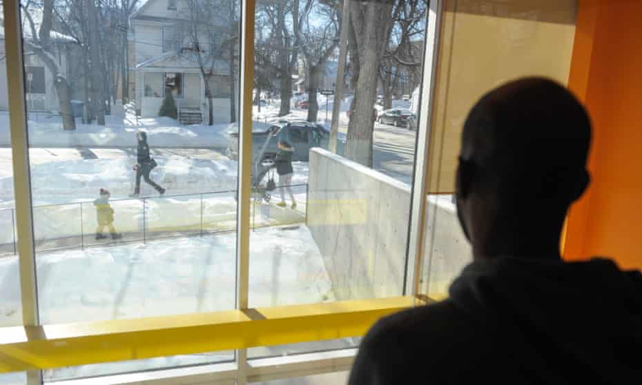A refugee claimant from Djibouti looks out the window of the Manitoba Interfaith Immigration Council shelter on 9 February after arriving with a group of other migrants that illegally crossed the US-Canada border to seek asylum in Canada.