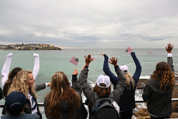 Team USA cheer on their teammates as they race across the bay.